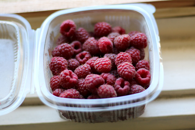 Raspberries, fresh, in a plastic container